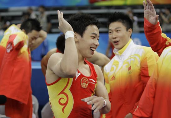 图文-体操男团决赛中国冲冠 邹凯(中)与队友击掌