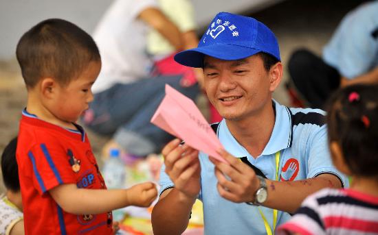 图文:广西志愿者在九洲体育馆外与孩子做游戏