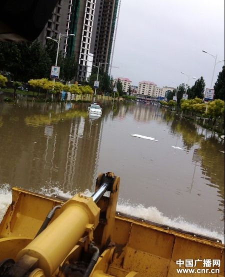 8月4日，秦皇岛市海港区西岗路上，一辆轿车被积水围困（刘磊摄）