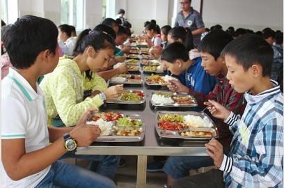 学校食堂建成后,学生们吃营养午餐.