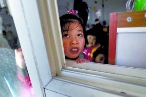 1月15日,彩虹桥幼儿园,一名孩子趴在窗户边朝外张望。该园面临拆除。本报记者 杨杰 摄 1月15日,彩虹桥幼儿园,一名孩子趴在窗户边朝外张望。该园面临拆除。本报记者 杨杰 摄