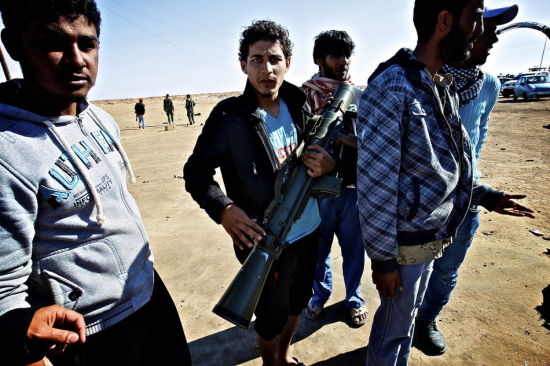 在利比亚艾季达比耶，反对派士兵展示缴获的武器。新华社记者 才扬 摄
