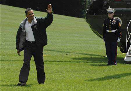 US President Barack Obama waves as he arrives via Marine One helicopter after a weekend visit to Camp David with his family, at the White House in Washington, August 2, 2009(Agencies)
