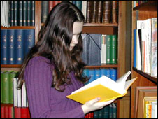 A student reading a book in the library