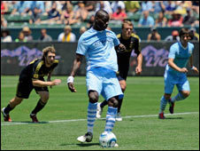 Manchester City's Mario Balotelli (in blue) takes a penalty in their match against LA Galaxy