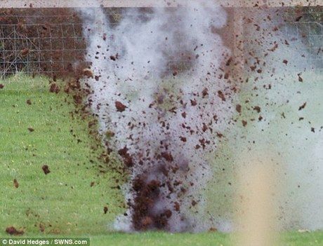 A Bomb disposal team carries out a controlled explosion at Holford Wood, West Somerset after a hand grenade was found. [Agencies]
