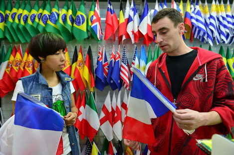 A businessman chooses flags for the coming World Cup in Brazil at the Yiwu International Trade City. [Photo / Asianewsphoto]