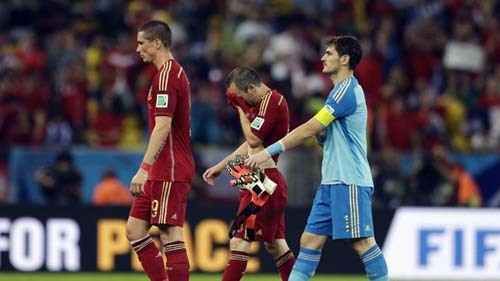 From left, Spain's Fernando Torres, Andres Iniesta and goalkeeper Iker Casillas walk off the pitch following their group B World Cup soccer match between Spain and Chile at the Maracana Stadium in Rio de Janeiro, Brazil, Wednesday, June 18, 2014. Defending champion Spain was eliminated from the World Cup after losing to Chile 2-0. 