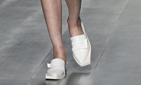 The white flat shoes of J. JS Lee