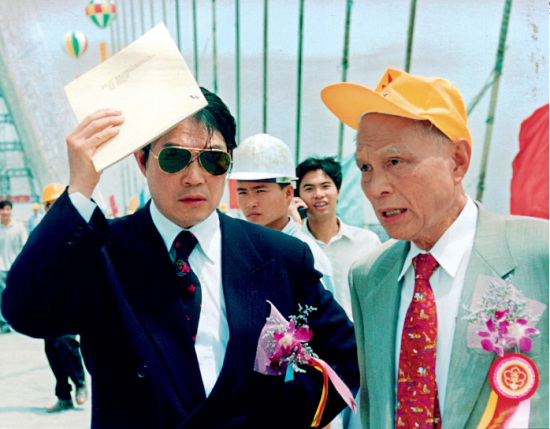 1999年，霍英东与霍震霆在番禺大桥工地视察。