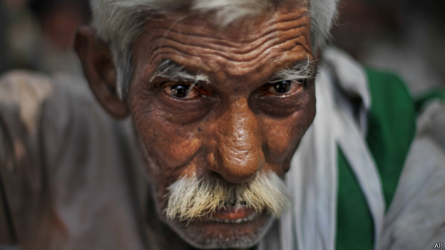 An elderly Indian farmer looks directly at the camera