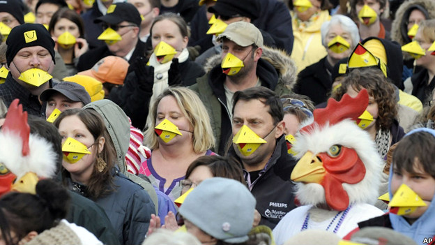 People pack a city square wearing chicken beaks in an attempt to set a world record for the most people wearing animal noses at a single venue.