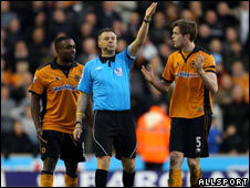 Sylvan Ebanks-Blake (L) and Richard Stearman (R) of Wolves protest to referee Mark Halsey following their team's disallowed goal