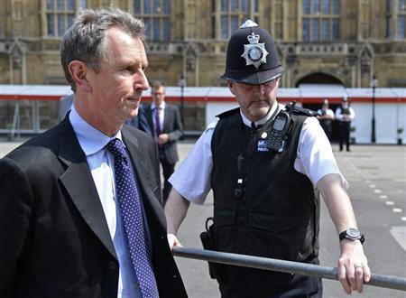 Conservative MP and deputy speaker of Britain's parliament Nigel Evans (L) arrives to make a news statement outside of the Houses of Parliament in London May 7, 2013.