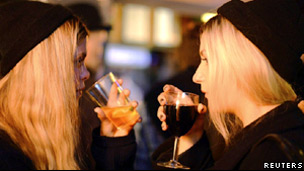 Two young women drinking in a club