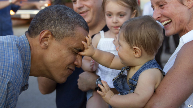 A baby touches the face of US president Barack Obama.