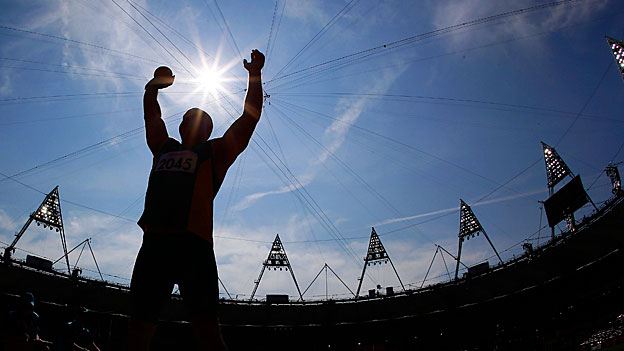 Australia's Russell Short stands silhouetted against the sun during the Men's shot put final at the Olympic Stadium. 