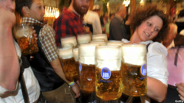 A waitress carries glasses of beer at the Oktoberfest in Munich, southern Germany.
