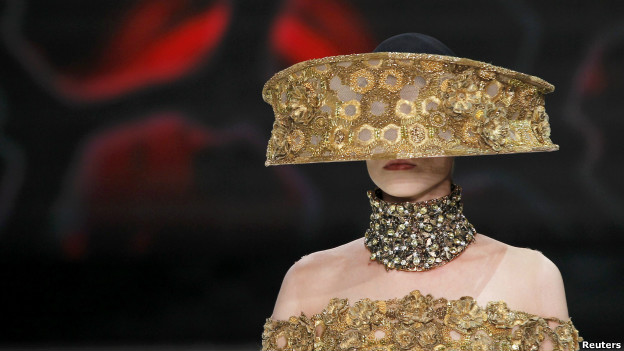 A model wears a gold headpiece by British designer Sarah Burton.