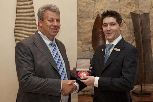 Saxon MD George Cohen presents Sommelier Franis Krone with his medal