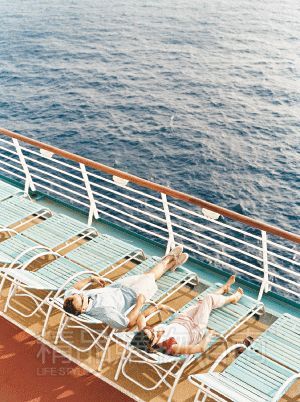 Lying on the deck, relaxed and comfortable.