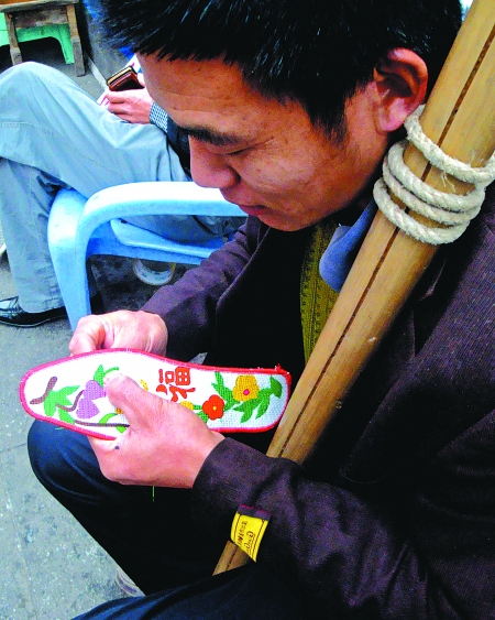 没活的时候,徐怀友就会坐在街边绣鞋垫.