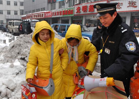 图文:合肥火车站民警帮助聋哑儿童提行李